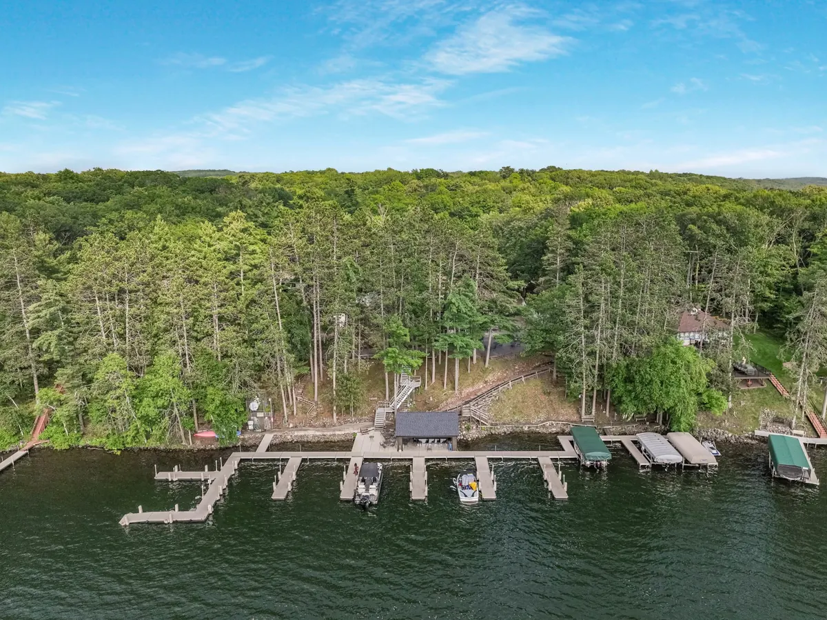 Aerial view of a wooded lakefront with docks