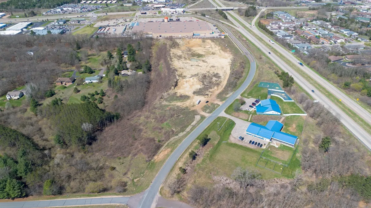 Aerial view of undeveloped land beside a highway